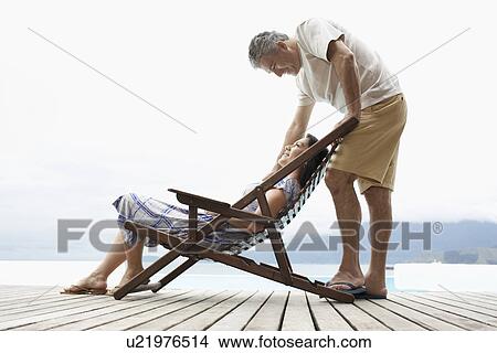 Mature couple relaxing on deck View Large Photo Image Picture - Mature couple relaxing on deck. Fotosearch