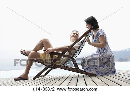 Mature couple relaxing on deck View Large Photo Image Stock Image - Mature couple relaxing on deck. Fotosearch