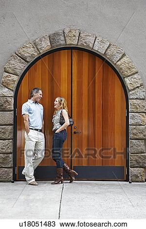 Mid Adult Couple Talking by Arched Door View Large Photo Image Stock Image - Mid Adult Couple Talking by Arched Door. Fotosearch