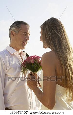 Newlyweds looking at each other View Large Photo Image Stock Photo - Newlyweds looking at each other. Fotosearch