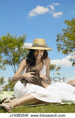 Stock Photograph - Young man resting head on woman's lap. Fotosearch