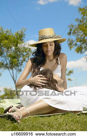 Stock Photograph - Young man resting head on woman's lap. Fotosearch