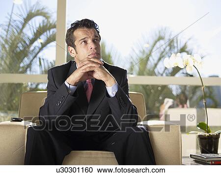 Stock Image - Businessman sitting on armchair. Fotosearch