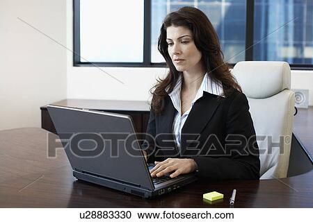Businesswoman working on laptop View Large Photo Image Stock Image - Businesswoman working on laptop. Fotosearch