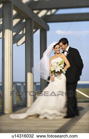 Bride and groom standing together View Large Photo Image Stock Image - Bride and groom standing together. Fotosearch