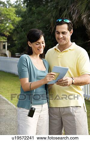 Couple holding map and smiling View Large Photo Image Stock Image - Couple holding map and smiling. Fotosearch