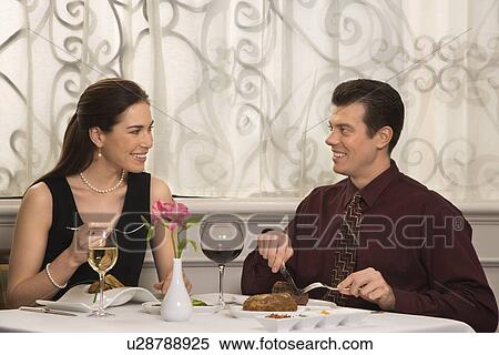 Couple smiling eating in restaurant View Large Photo Image Stock Photography - Couple smiling eating in restaurant. Fotosearch