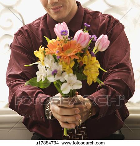 Picture - Man holding bouquet of flowers. Fotosearch