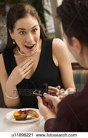 Stock Image - Man proposing marriage at a restaurant. Fotosearch