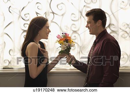 Man surprised woman with bouquet View Large Photo Image Stock Photo - Man surprised woman with bouquet. Fotosearch
