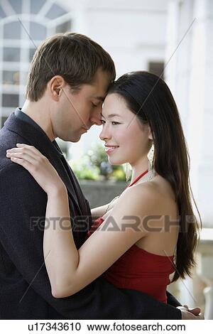 Woman and man outdoors embracing each other View Large Photo Image Stock Image - Woman and man outdoors embracing each other. Fotosearch