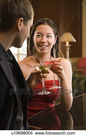 Woman and man toasting martinis View Large Photo Image Stock Photography - Woman and man toasting martinis. Fotosearch