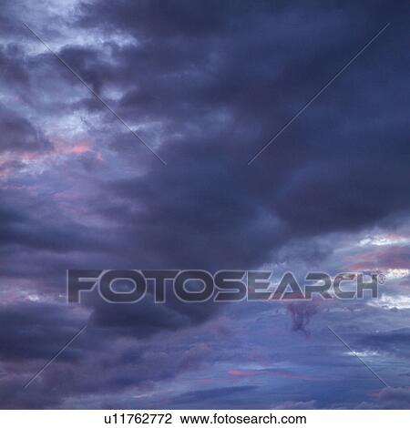 Dark ominous storm clouds spreading across sky View Large Photo Image Stock Image - Dark ominous storm clouds spreading across sky. Fotosearch