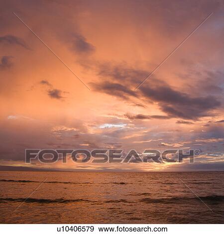 Orange glowing clouds during sunset on coast View Large Photo Image Stock Photo - Orange glowing clouds during sunset on coast. Fotosearch