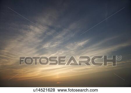 Wispy clouds at sunset View Large Photo Image Stock Photo - Wispy clouds at sunset. Fotosearch