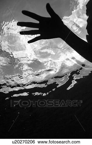 Stock Photograph - Female hand pressing on water. Fotosearch