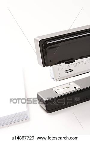 Close up of black stapler on white background with stack of paper View Large Photo Image Stock Photo - Close up of black stapler on white background with stack of paper. Fotosearch