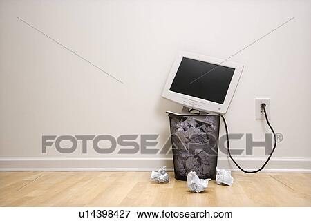 Computer monitor in trash can surrounded by crumpled up paper View Large Photo Image Stock Photo - Computer monitor in trash can surrounded by crumpled up paper. Fotosearch