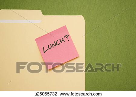 Stock Image - Folder with pink sticky note reading lunch on a green background.. Fotosearch