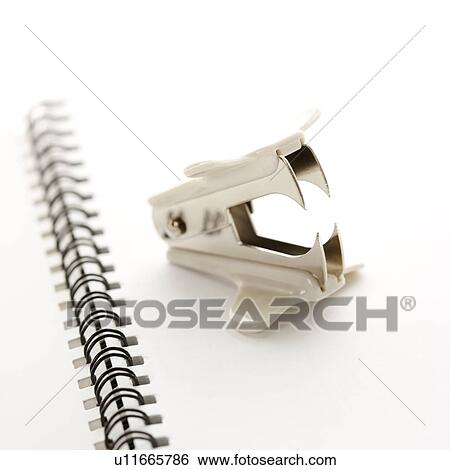 Staple remover on top of an open spiral bound notebook. View Large Photo Image Stock Photograph - Staple remover on top of an open spiral bound notebook.. Fotosearch