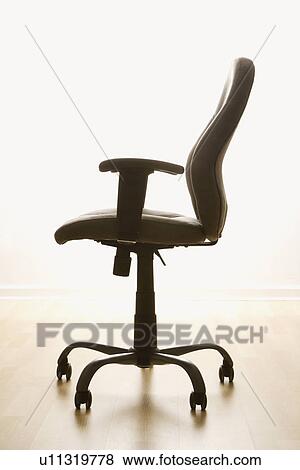 Still life of empty office desk chair. View Large Photo Image Stock Photo - Still life of empty office desk chair.. Fotosearch