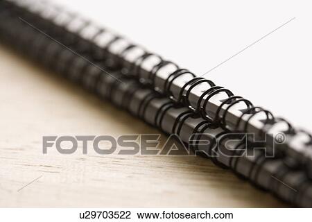 Stock Image - Two spiral bound notebooks with selective focus. Fotosearch
