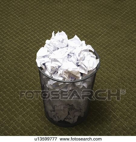 Wire mesh trash can filled with crumpled paper on green carpet. View Large Photo Image Stock Photo - Wire mesh trash can filled with crumpled paper on green carpet.. Fotosearch