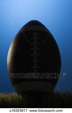 Studio shot of silhouette football resting in grass. View Large Photo Image Stock Photo - Studio shot of silhouette football resting in grass.. Fotosearch
