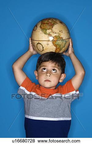 Stock Photo - Boy holding globe on head. Fotosearch