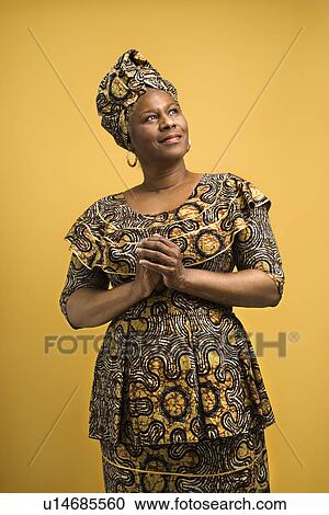 Stock Image - Female mature adult in African dress. Fotosearch