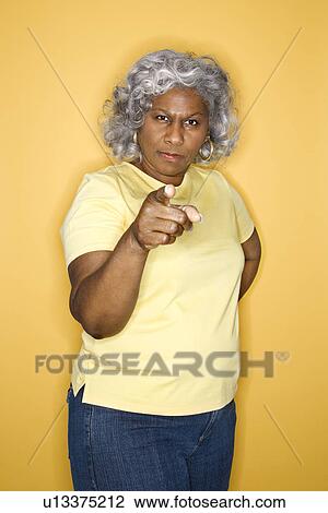 Stock Image - Female standing pointing. Fotosearch