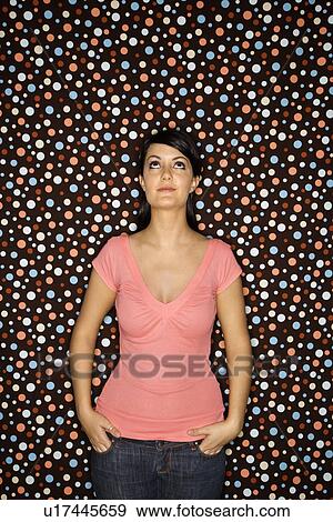 Stock Photo - Female standing with hands in pockets . Fotosearch