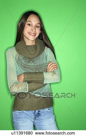 Stock Image - Girl with arms crossed standing. Fotosearch