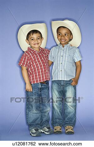 Hispanic and African American male child in cowboy hats. View Large Photo Image Stock Image - Hispanic and African American male child in cowboy hats.. Fotosearch