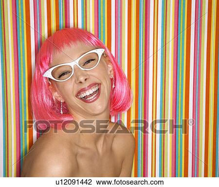 Portrait of attractive Caucasian young adult woman wearing pink wig against striped background making sassy expression looking at viewer. View Large Photo Image Stock Image - Portrait of attractive Caucasian young adult woman wearing pink wig against striped background making sassy expression looking at viewer.. Fotosearch