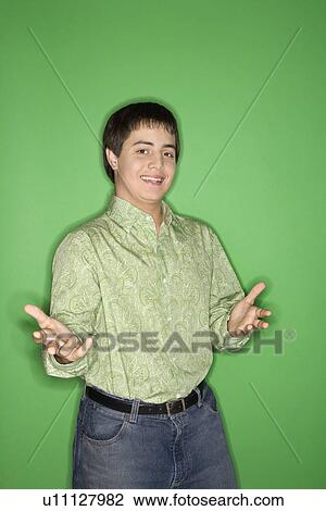 Portrait of Caucasian teen boy with hands opened towards viewer standing against green background. View Large Photo Image Stock Image - Portrait of Caucasian teen boy with hands opened towards viewer standing against green background.. Fotosearch