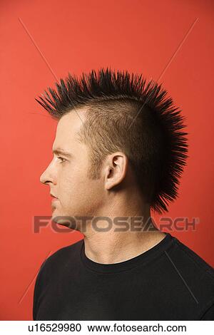 Profile portrait of Caucasian man with spiked mohawk against orange background. View Large Photo Image Stock Image - Profile portrait of Caucasian man with spiked mohawk against orange background.. Fotosearch