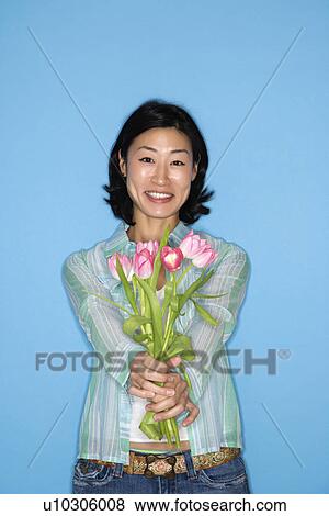 Stock Photo - Woman holding flowers . Fotosearch