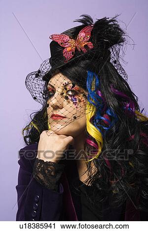 Stock Image - Woman in unique makeup and clothing . Fotosearch