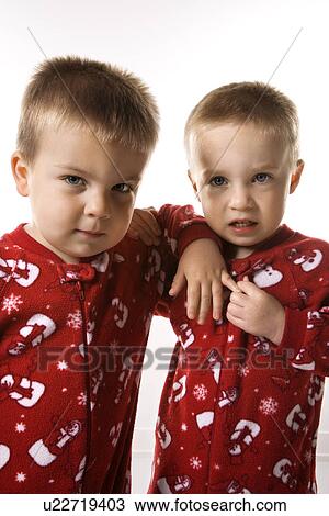 Caucasian male twin children leaning on eachother. View Large Photo Image Stock Image - Caucasian male twin children leaning on eachother.. Fotosearch