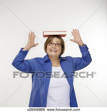 Caucasian middle aged woman balancing book on head. View Large Photo Image Stock Photograph - Caucasian middle aged woman balancing book on head.. Fotosearch