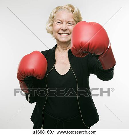 Caucasian senior woman wearing boxing gloves and throwing punch at viewer. View Large Photo Image Stock Photo - Caucasian senior woman wearing boxing gloves and throwing punch at viewer.. Fotosearch