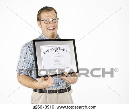 Stock Image - Caucasian young man dressed like nerd holding certificate and smiling.. Fotosearch