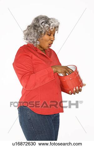 Mature adult African American female with hand in jar. View Large Photo Image Stock Image - Mature adult African American female with hand in jar.. Fotosearch