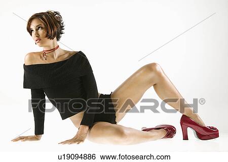 Stock Photograph - Pretty Caucasian young woman posed in studio.. Fotosearch