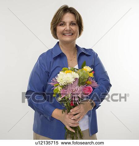 Woman holding bouquet of flowers View Large Photo Image Stock Photography - Woman holding bouquet of flowers. Fotosearch