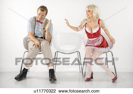 Woman sitting reaching over to shy young man dressed like nerd View Large Photo Image Stock Image - Woman sitting reaching over to shy young man dressed like nerd. Fotosearch