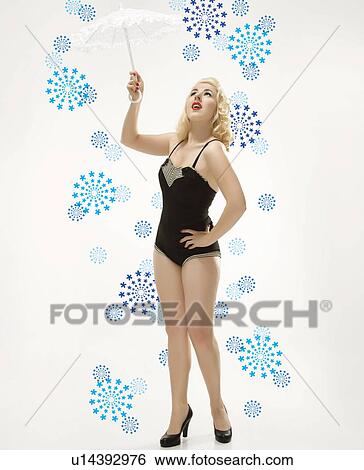 Woman wearing retro swimsuit in pinup pose with umbrella View Large Photo Image Stock Photograph - Woman wearing retro swimsuit in pinup pose with umbrella. Fotosearch