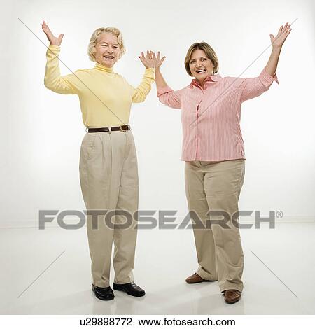 Stock Image - Women with arms in air. Fotosearch