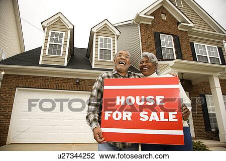 Couple outside house with for sale sign View Large Photo Image Stock Image - Couple outside house with for sale sign. Fotosearch